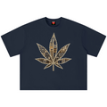 A navy blue short-sleeve t-shirt with a large cannabis leaf graphic on the chest, constructed from gold and brown geometric patterns, shown against a plain white background.