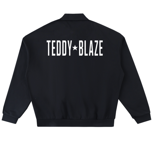 Elevate your athletic layering with the House of Teddy Blaze Statement Fleece Long Button Polo. Black 445 gsm fleece, lapel collar, button placket, and bold star block typography. Shop NYC to Vegas style.