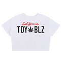 A white short-sleeve crop top t-shirt featuring a graphic print on the front. The design includes the word 'California' in red cursive script above the text 'TDY BLZ' in bold black letters, where the 'O' is replaced by a black cannabis leaf.