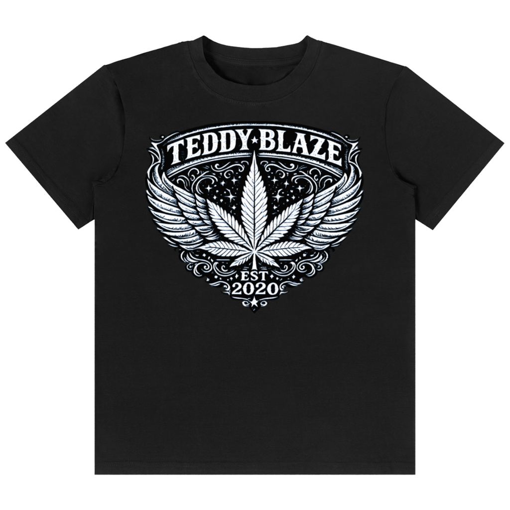 Shop the Flying High Classic Tee by Teddy Blaze. 180 GSM cotton-spandex stretch tee featuring an ornate winged crest graphic from the TOPS line of The Mature Mocha Collection.