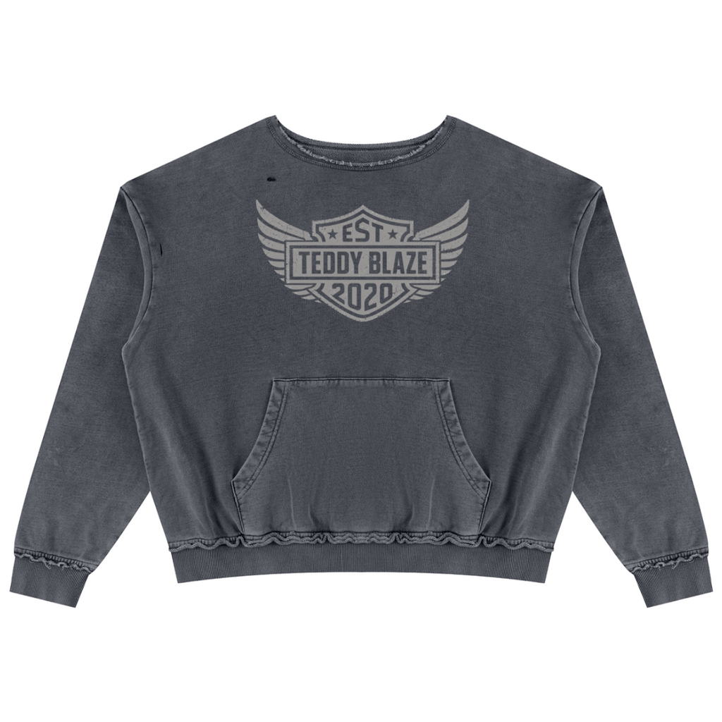 Shop the Freedom Crest Cotton Trucker Jumper by Teddy Blaze. Heavyweight 400 gsm snow-wash cotton crewneck sweater featuring a distressed hem, front pouch pocket, and DaCruz back print.
