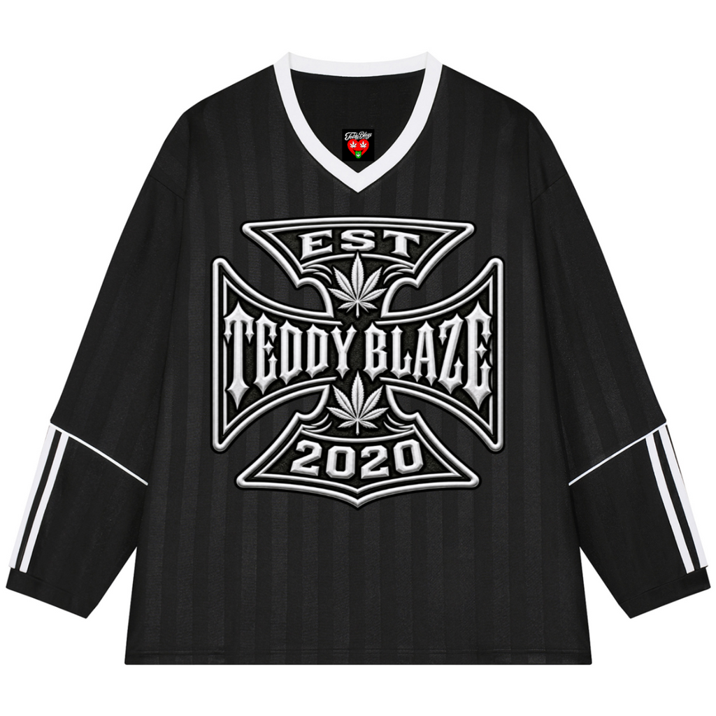 A black long-sleeve hockey-style jersey with white trim on the V-neck and sleeve cuffs, featuring a large white graphic on the chest that reads 'TEDDY BLAZE EST 2020' with a cannabis leaf motif. The sleeves also have white stripe details.