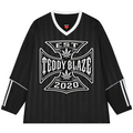 A black long-sleeve hockey-style jersey with white trim on the V-neck and sleeve cuffs, featuring a large white graphic on the chest that reads 'TEDDY BLAZE EST 2020' with a cannabis leaf motif. The sleeves also have white stripe details.
