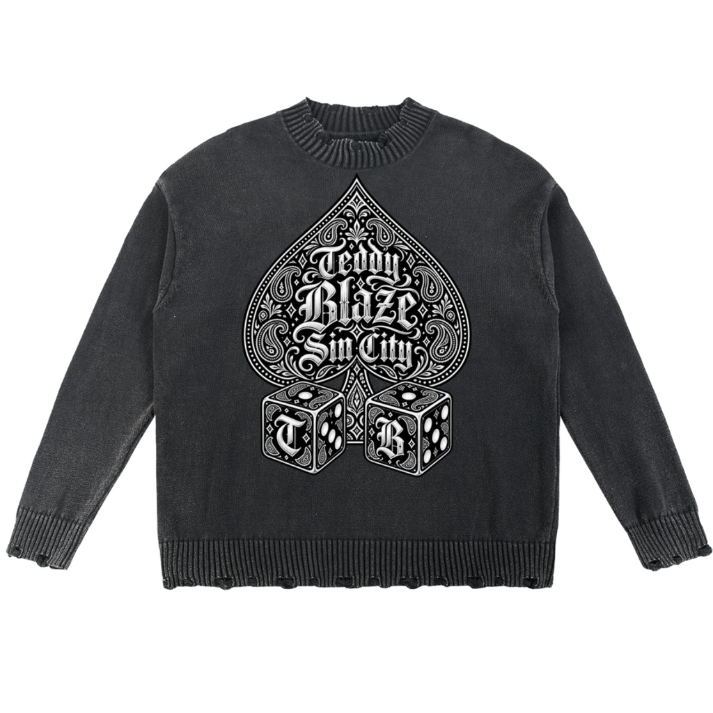 Elevate your knitwear with the House of Teddy Blaze High Roller Vintage Washed Hand-Frayed Cotton Sweater. Charcoal cotton knit, hand-frayed trim, Ace of Spades graphic, and Sin City dice print. Shop NYC to Vegas style.