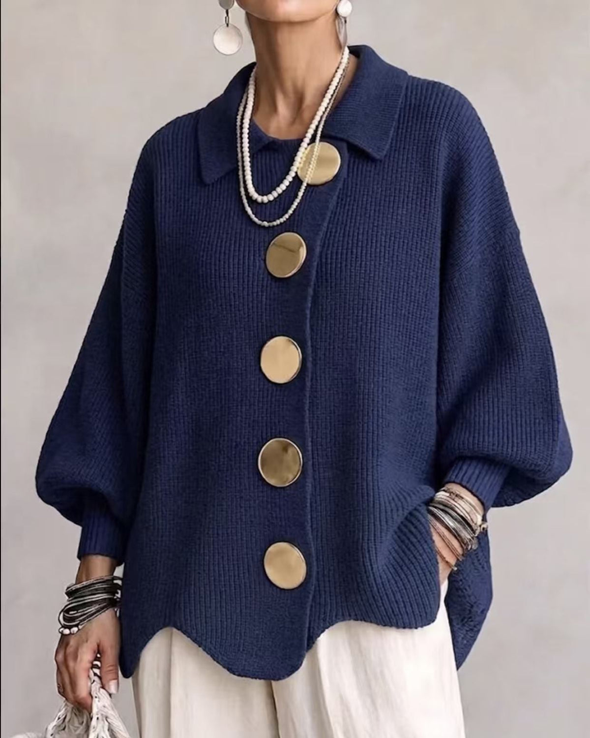 hop the Highland Statement Button Knit Cardigan Jacket by Ella Adire. Ribbed knit cardigan featuring oversized metallic buttons, turn-down collar, and lantern sleeves.