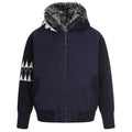 Elevate your luxury outerwear with the House of Teddy Blaze Hybrid Knit Faux Fur Hooded Jacket. Navy blue nylon and ribbed knit hybrid shell, insulated fill, faux fur hood lining, and geometric sleeve graphics. Shop NYC to Vegas style.