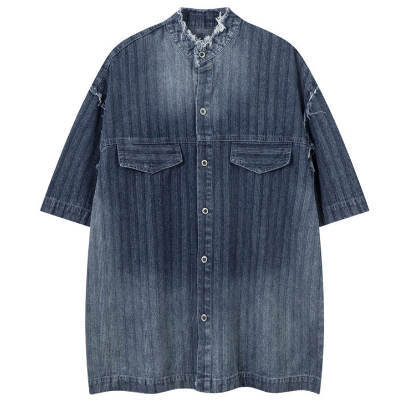 Shop the Iron + Ivy Distressed Denim Stand Collar Short Sleeve Shirt by Teddy Blaze. Oversized indigo short-sleeve denim shirt featuring raw frayed collars, self-striping, and metal snap hardware.