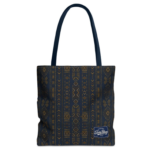 Carry more in the Teddy Blaze Mud of Indigo Grab + Go Bag, an 18" oversized tote featuring indigo mudcloth-inspired artwork, boxed corners and reinforced handles.