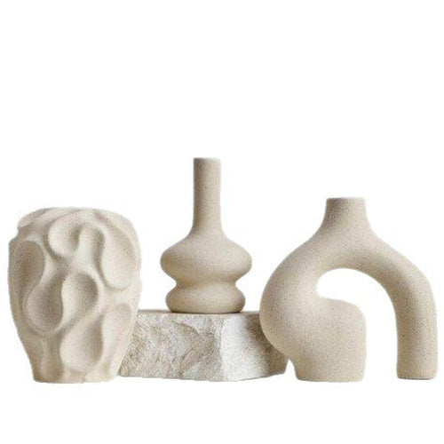 Shop the Nordic Irregular Ceramic Vase Trio Set by Teddy Blaze. Minimalist white porcelain decorative vases featuring organic textured curves and sculptural forms.