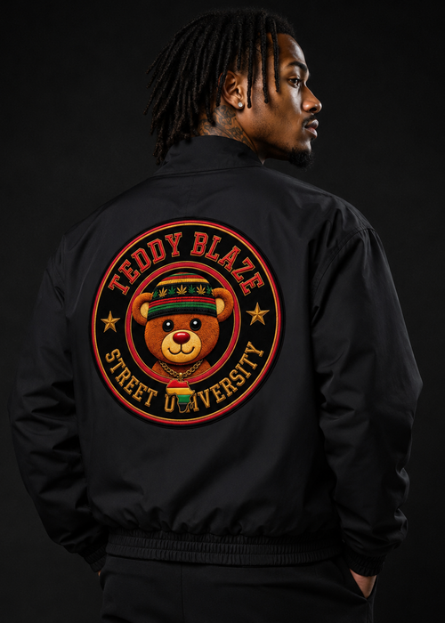 A man shown from the back wearing a black bomber jacket with a large circular graphic on the back. The graphic features a cartoon teddy bear wearing a green and red hat, surrounded by the text 'TEDDY BLAZE' and 'STREET UNIVERSITY'.