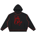 A black cropped hoodie with red piping and a red script 'Teddy Blaze' logo on the chest, displayed against a solid white background.