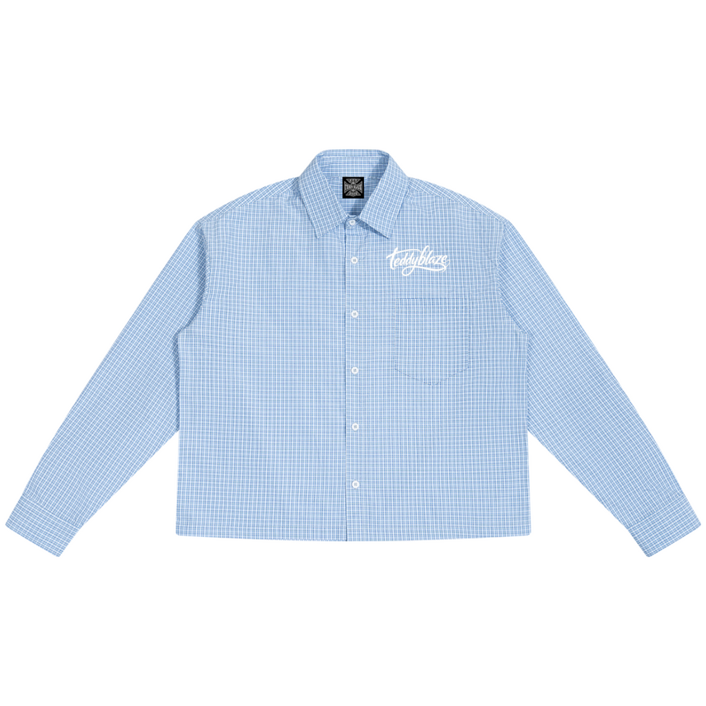 Shop the Signature Boxy Plaid Long Sleeve Shirt by Teddy Blaze. 100 GSM lightweight blue plaid button-up shirt with white script embroidery from HIGH ROLLERS OUTERWEAR.