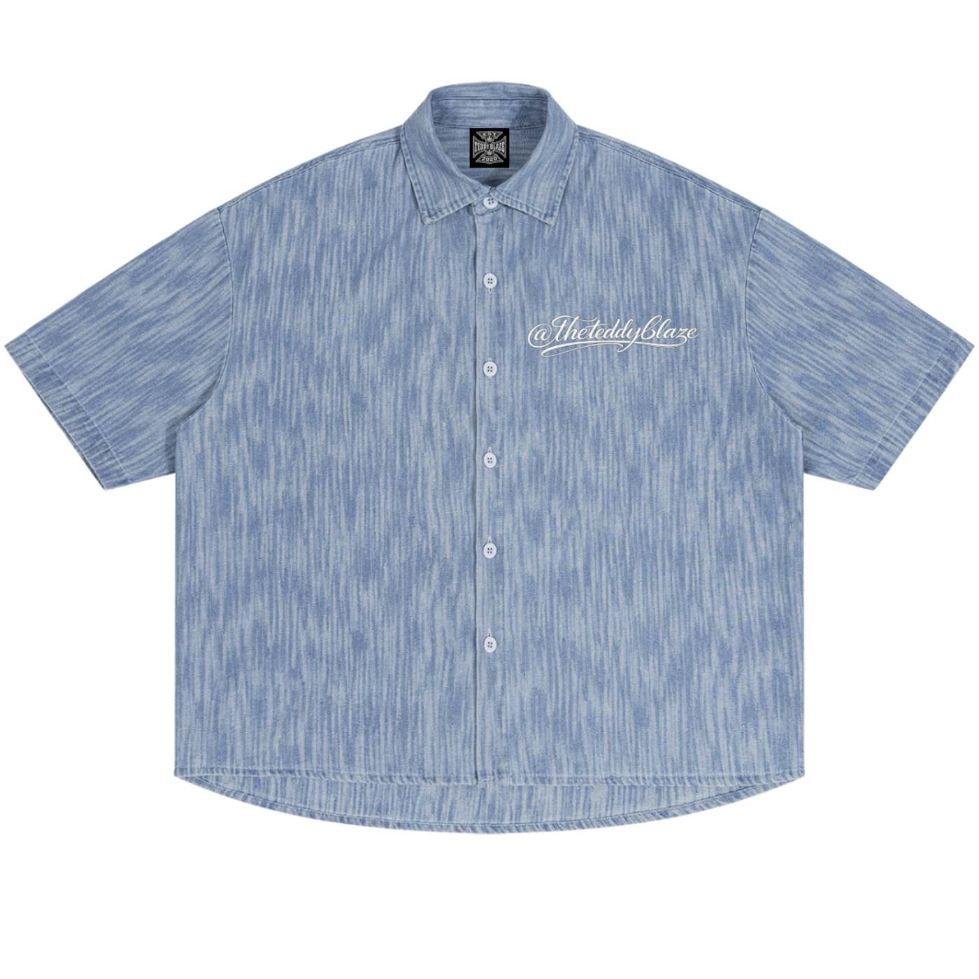 Shop the Signature Boxy Vintage Wash Denim Camp Shirt by Teddy Blaze. Lightweight 230 GSM blue striated denim short sleeve button-up from THE BLAZE MAN.