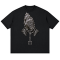Elevate your streetwear with the Teddy Blaze Sin City Drop Shoulder Cotton Tee. Black cotton, tattoo praying hands print, and Sin City back graphic. Shop NYC to Vegas style.