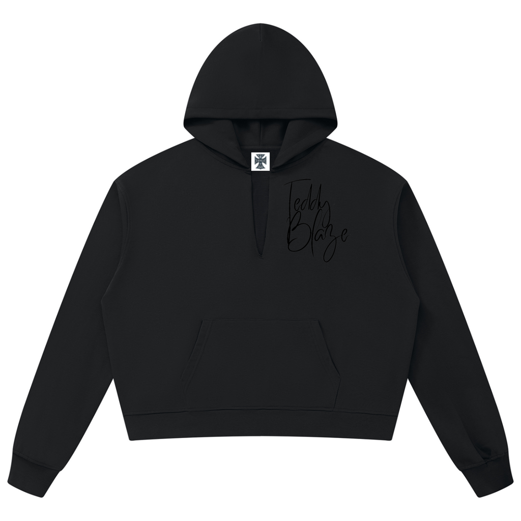 Elevate your casual outerwear with the House of Teddy Blaze Signature V-Neck Box Cut Raw Edge Hoodie. Black 360 gsm fleece, notched V-neck hood collar, raw edge details, and tonal script logo. Shop NYC to Vegas style.