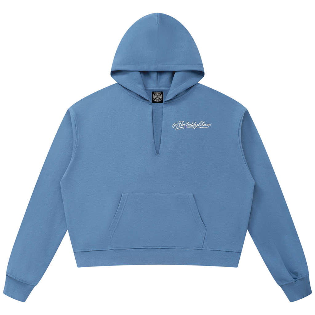 Shop the Signature V-Neck Boxy Raw Edge Hooded Jumper by Teddy Blaze. 360 GSM slate blue heavy fleece hoodie featuring a slit V-neck cut from THE BLAZE MAN.