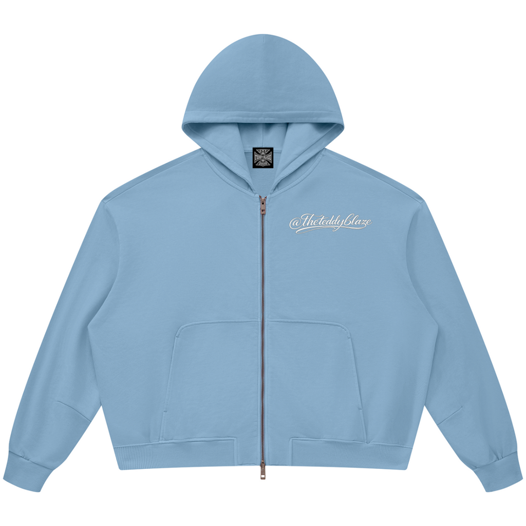 Shop the Signature Vintage Wash Boxy Zip Hoodie by Teddy Blaze. 360 GSM slate blue cotton zip hoodie featuring white script branding from THE BLAZE MAN.