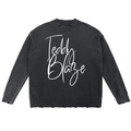 Elevate your knitwear with the House of Teddy Blaze Signature Vintage Washed Hand-Frayed Cotton Sweater. Charcoal cotton knit, hand-frayed trim, and script logo chest graphic. Shop NYC to Vegas style.