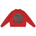 Elevate your cold-weather layers with the Teddy Blaze Sin City Fleece Mock-Neck Jumper. Red heavy fleece, ribbed mock neck, and ornate Sin City logo chest print. Shop NYC to Vegas style.