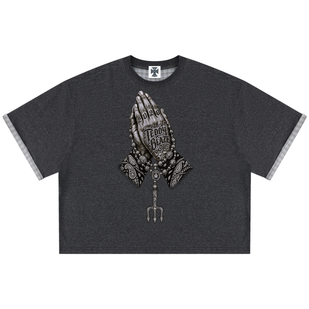 Elevate your casualwear with the Teddy Blaze Sin City Sacred Plaid-Lined Double-Face Tee. Charcoal stretch-cotton, exposed plaid trim, and tattoo praying hands print. Shop NYC to Vegas style.