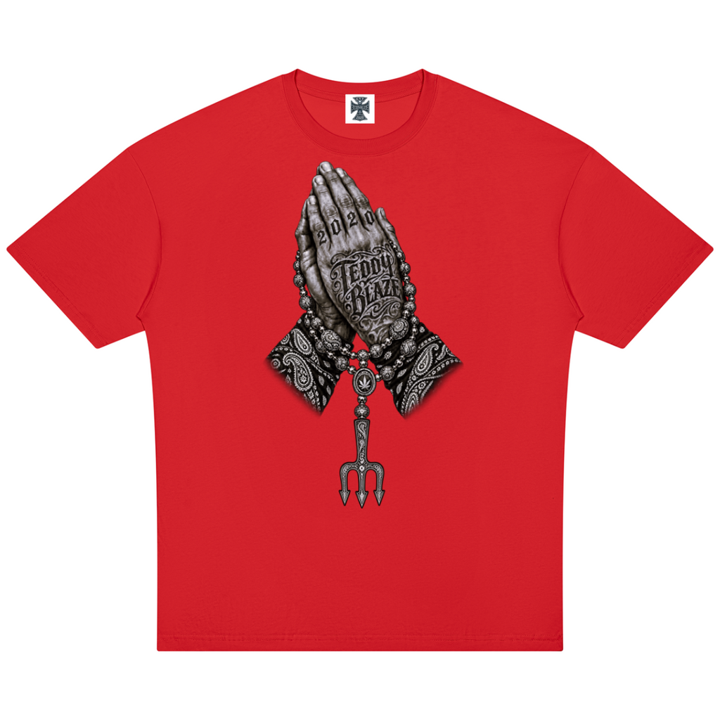 Elevate your streetwear with the Teddy Blaze Sin City Sacred Cotton Drop Shoulder Tee. Red cotton, tattoo praying hands print, and ornate back graphic. Shop NYC to Vegas style.