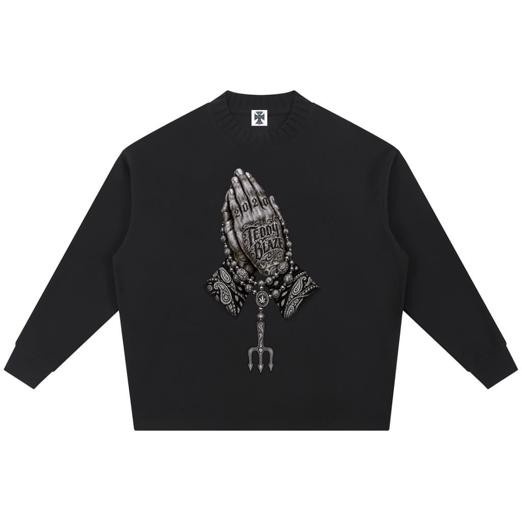 Elevate your knitwear with the Teddy Blaze Sin City Sacred Ribbed Knit Jumper. Black ribbed cotton-poly knit, praying hands chest graphic, and ornate Sin City back print. Shop NYC to Vegas style