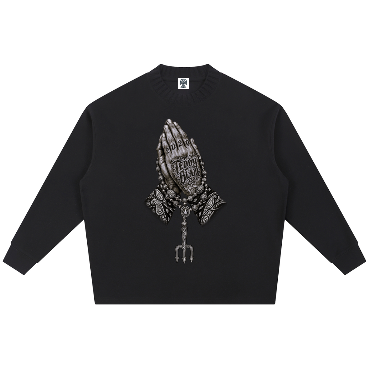 Elevate your knitwear with the Teddy Blaze Sin City Sacred Ribbed Knit Jumper. Black ribbed cotton-poly knit, praying hands chest graphic, and ornate Sin City back print. Shop NYC to Vegas style