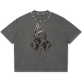 Elevate your boxy graphic tees with the Teddy Blaze Sin City Sacred Snow Wash Studded Cotton Tee. Charcoal snow-washed cotton, metal studded collar, and tattoo praying hands print. Shop NYC to Vegas style.