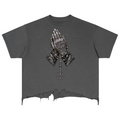 Elevate your distressed streetwear with the Teddy Blaze Sin City Sacred Vintage Wash Distressed Hem Tee. Charcoal gray cotton, frayed raw hem, and tattoo praying hands graphic. Shop NYC to Vegas style.