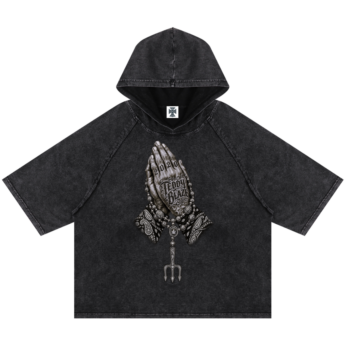 Elevate your casualwear with the Teddy Blaze Sin City Snow Washed Hooded Box Cut Tee. Charcoal snow-washed cotton blend, short raglan sleeves, hood, and tattoo praying hands graphic. Shop NYC to Vegas style.