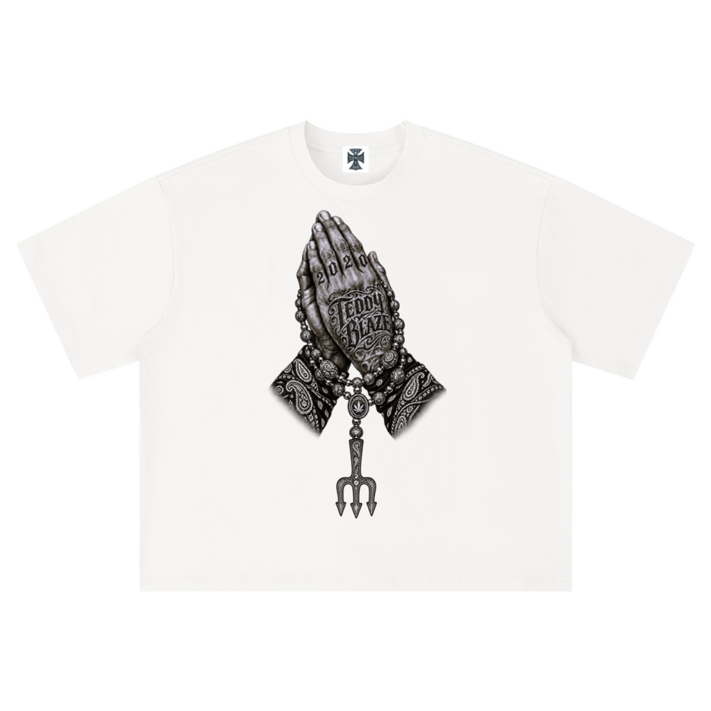 Elevate your streetwear with the Teddy Blaze Sin City Sacred Box Cut T-Shirt. Black stretch-cotton, tattoo praying hands print, and boxy cut. Shop NYC to Vegas style.