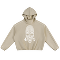 A beige cropped hoodie with a white graphic print of an African face on the front, displayed against a solid white background.