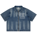 A short-sleeve denim jacket with a front zipper, featuring 'House of Teddy Blaze' printed in white outline text on the left chest and a small logo patch on the collar, shown against a plain white background.