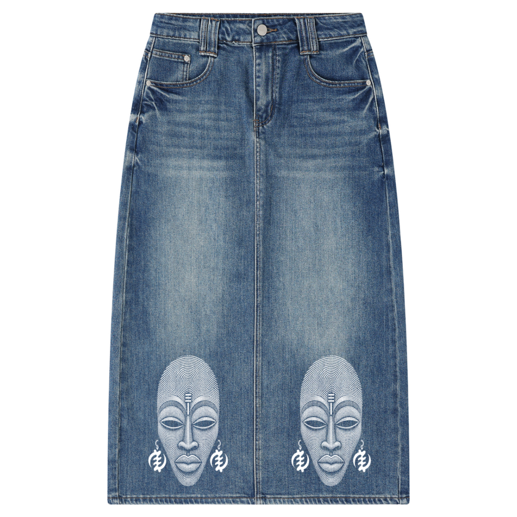 A medium wash blue denim skirt with two large white printed African face masks on the lower front, displayed flat against a white background.