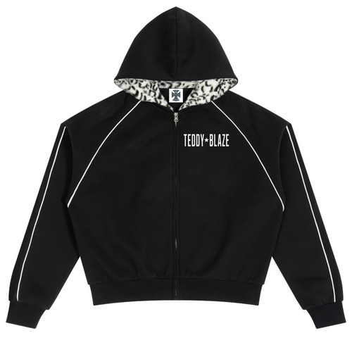 Elevate your statement outerwear with the House of Teddy Blaze Statement Piping + Leopard Detail Fleece Zip Hoodie. Crimson red 305 gsm fleece, contrast white piping, leopard faux fur hood lining, and bold star block typography. Shop NYC to Vegas style.